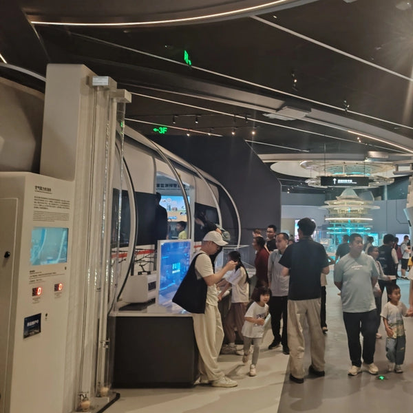 Immersive interactive museum exhibits in a modern science center gallery, designed for visitor engagement.