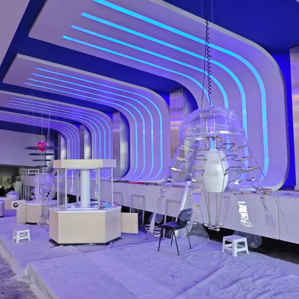 Technicians performing system assembly and calibration on a custom interactive science exhibit in a museum.