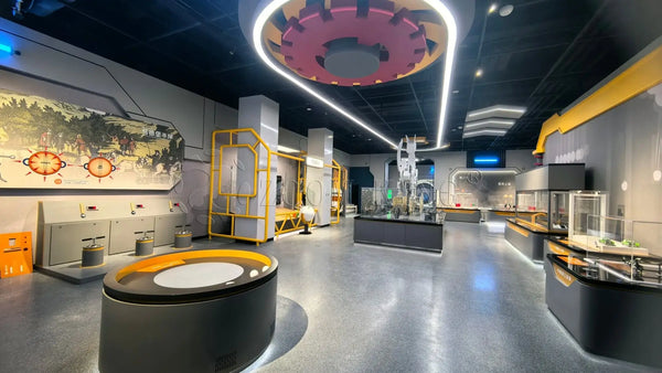 Interactive science exhibits in a modern science museum hall with hands-on physics and bicycle energy displays
