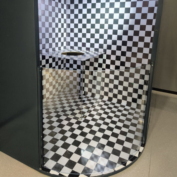 Visitor experiencing the invisible man plane mirror illusion exhibit