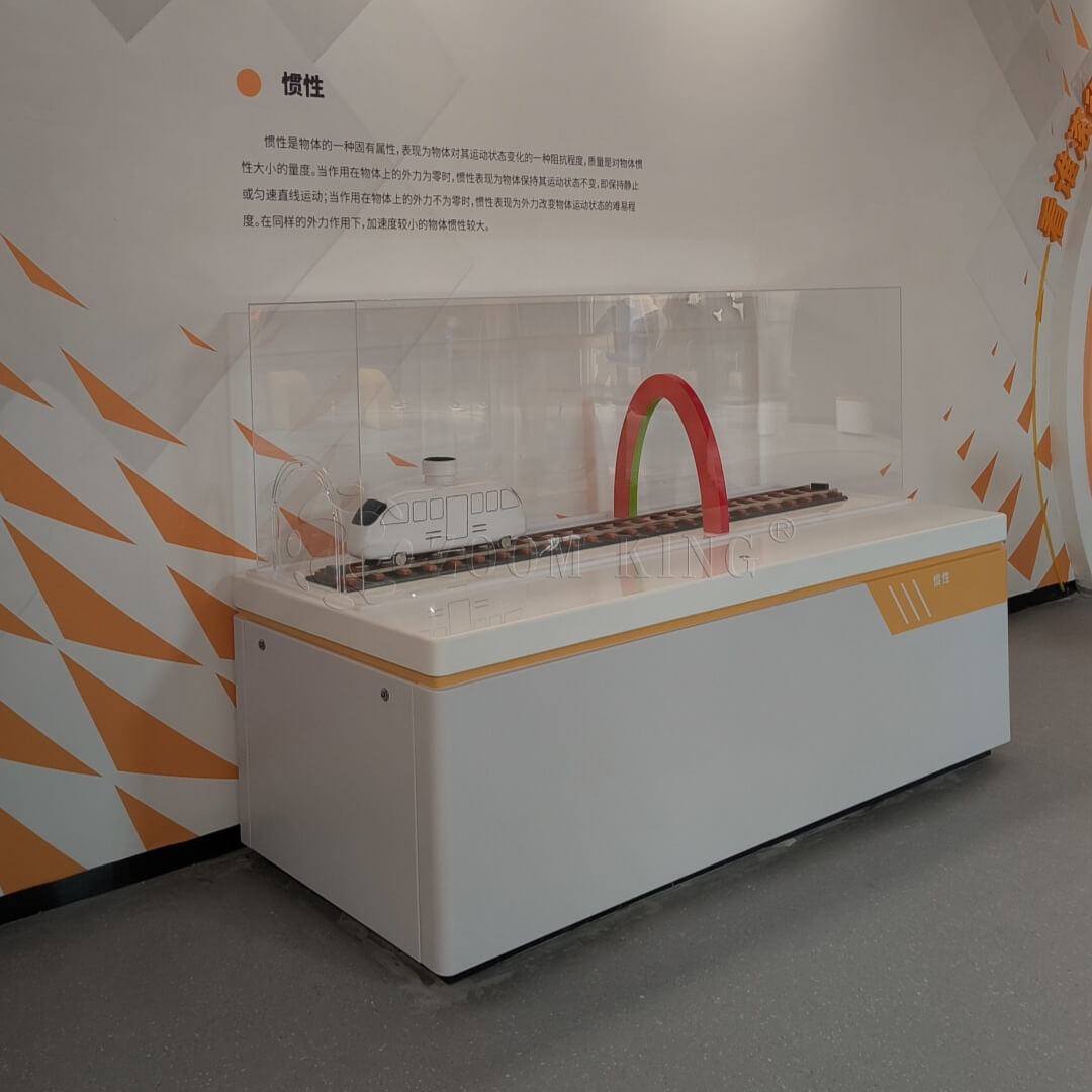 Visitors using Newton’s Second Law interactive physics exhibit in museum
