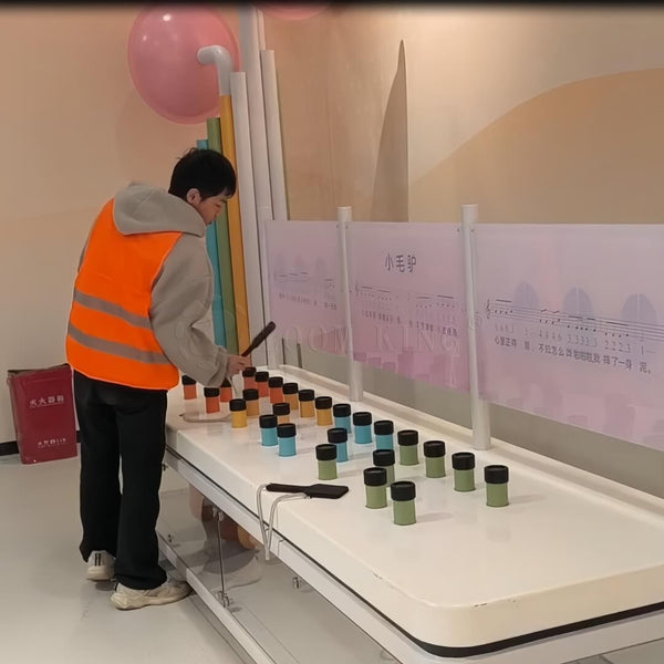 Children interacting with pipeline music sound exhibit in a science museum