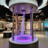 Interactive tornado formation exhibit demonstrating rotating airflow in a science museum environment