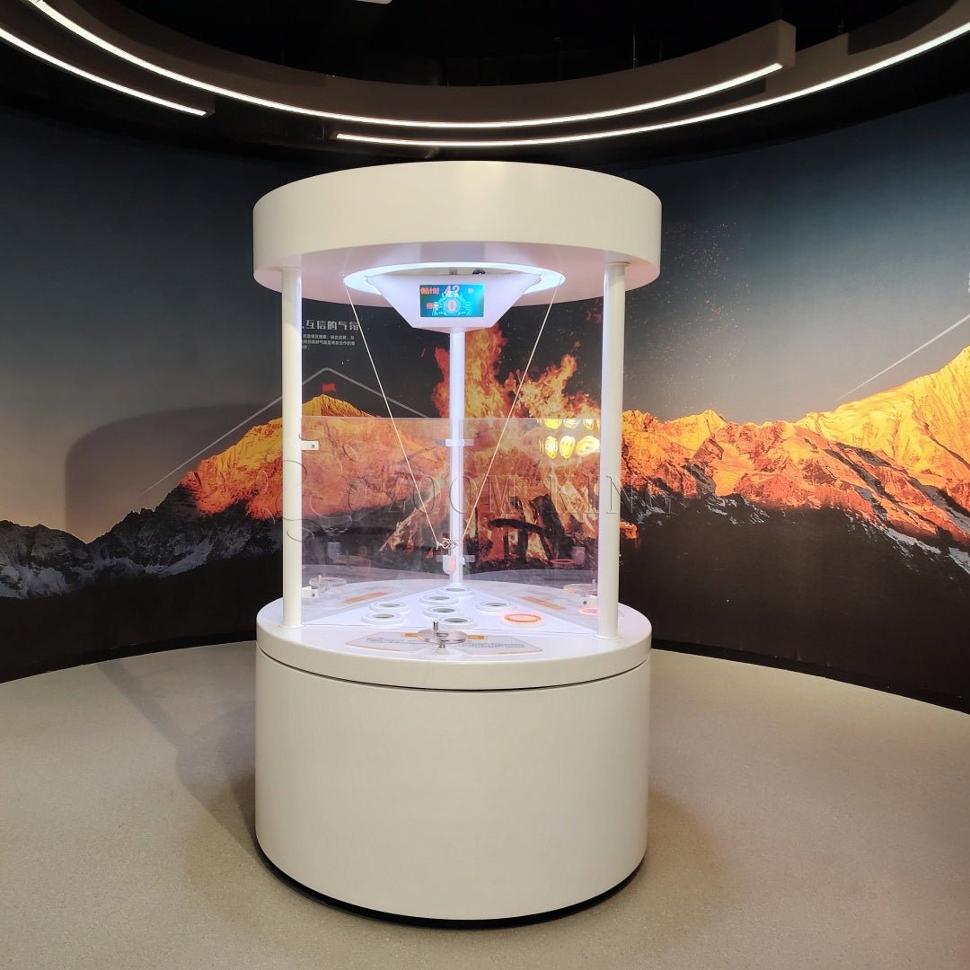 Visitors collaborating in cooperative ball movement interactive science exhibit